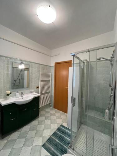 a bathroom with a sink and a glass shower at Blue House in Martinsicuro