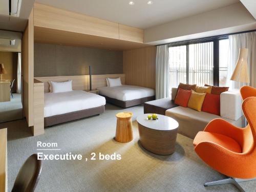 a hotel room with a bed and a couch at Mitsui Garden Hotel Kashiwa-No-Ha - Chiba in Kashiwa