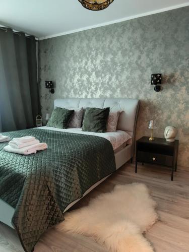 a bedroom with a bed with a furry rug at JOJO Loft Comfort Dzelzavas & Cozy Stay & Breakfast Gift in Riga