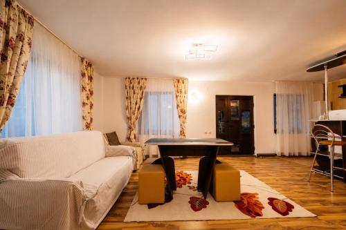 a living room with a couch and a table at Casa Valeria Voronet in Voronet