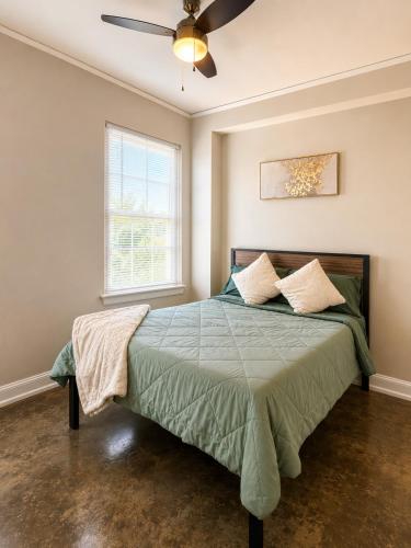 a bedroom with a bed with a ceiling fan at The Haven Loft in Birmingham