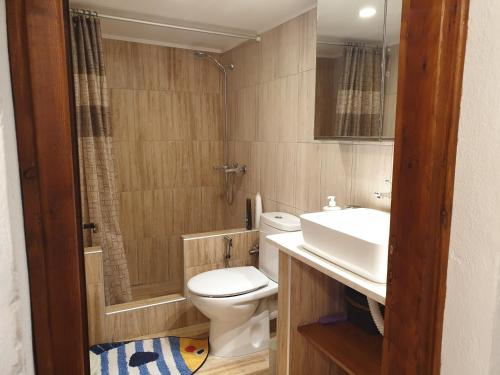 a bathroom with a toilet and a sink at Kanari Holiday Home in Gourna