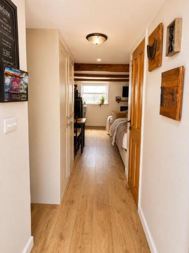 a hallway with a room with a bed and a desk at The Old Smithy in Trefriw
