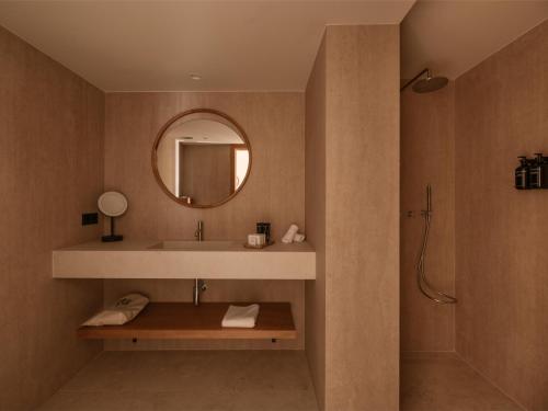 a bathroom with a sink and a mirror at Besai Ibiza Boutique Hotel - New Opening in San Jose