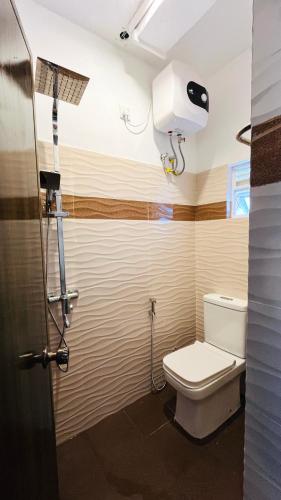 a bathroom with a toilet and a shower at Ayubo Villa in Ja-Ela
