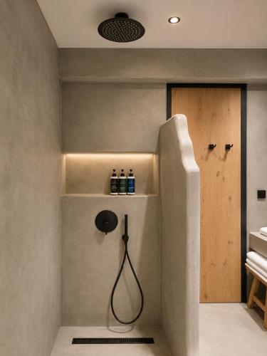 a bathroom with a shower with a hose at Summer Scents Villa Sani by Granari Rentals in Sani Beach