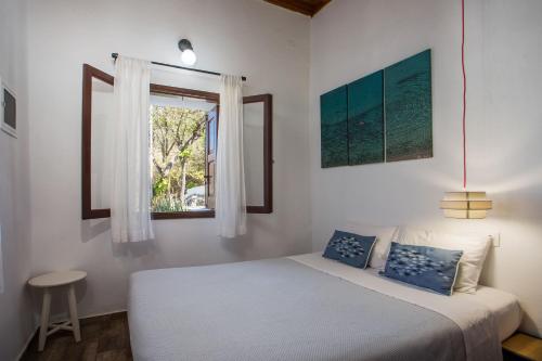 a bedroom with a bed and a window at CasaLindos Spitaki in Lindos