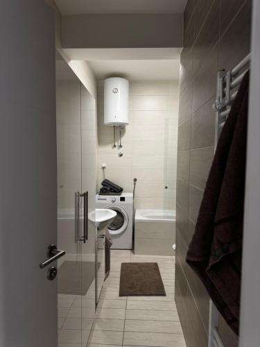 a bathroom with a washing machine and a sink at SIENA stan na dan Doboj in Doboj
