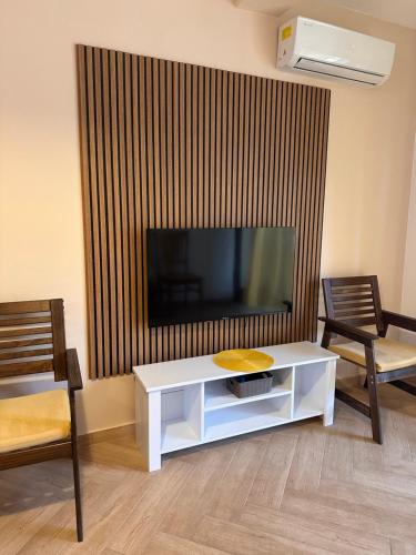 a living room with a tv and a white coffee table at Capri apartments in Kotor
