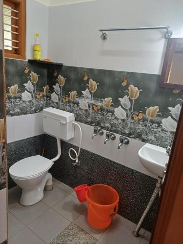 a bathroom with a toilet and a sink at Gramasiri Homestay in Sringeri