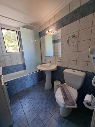a bathroom with a toilet and a sink at Stefanos Studios in Lassi