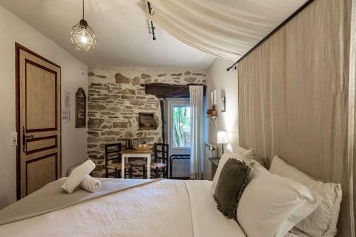 a bedroom with a bed with a teddy bear on it at la Ferme de Vazerat in Massiac