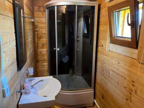 a bathroom with a shower and a toilet and a sink at Anna Beach Holiday Home in Raja