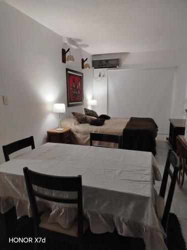 a room with two beds and a table and a couch at Mitre1349bis in Villa Basso