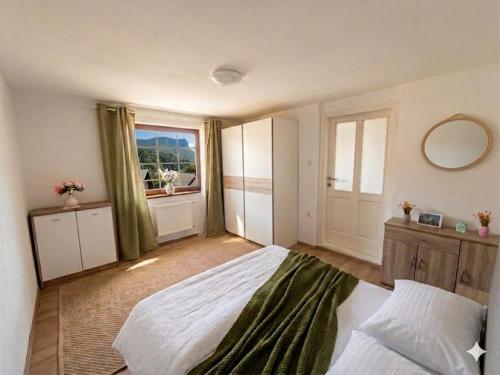 a bedroom with a large bed and a window at Under Rock Guesthouse in Bled