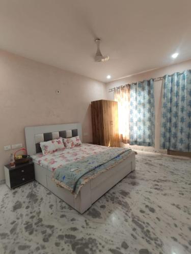 a bedroom with a large bed in a room at Om Homestay in Panchkula