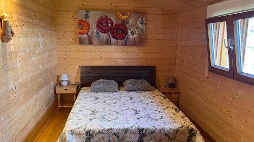 a bedroom with a bed in a wooden room at Anna Beach Holiday Home in Raja