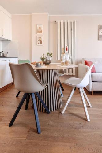 a living room with a table and two chairs at Casa Rheinblick - Apartment B in Basel