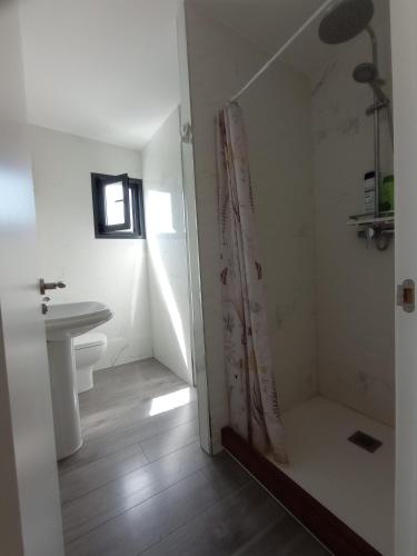 a bathroom with a sink and a shower curtain at solar eclipse house in Husillos