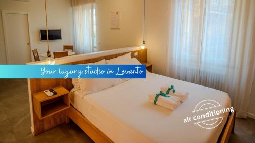 a bedroom with a bed with towels on it at Isabella Boutique Rooms in Levanto