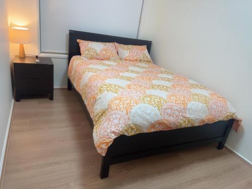 a bedroom with a bed with a comforter and pillows at Private Rm3 with Queen bed in Elderslie