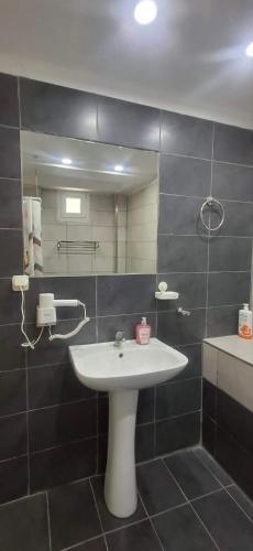 a bathroom with a sink and a mirror at Alekas Garden View Studios in Kos