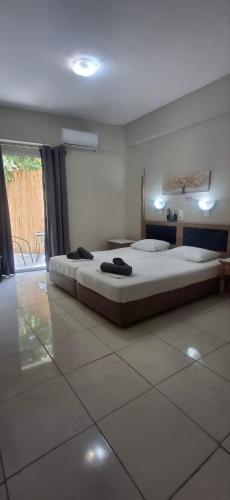 a bedroom with a large bed in a room at Alekas Garden View Studios in Kos