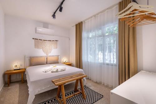 a white bedroom with a bed and a window at 7a old Marmaris house in Marmaris