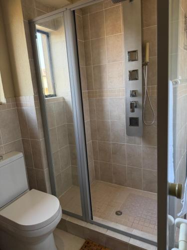 a bathroom with a shower with a toilet at Caly Luxury Home in Nelspruit