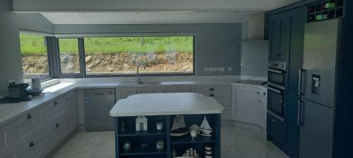 a kitchen with a island in the middle of it at Tigh an Trá in Bantry