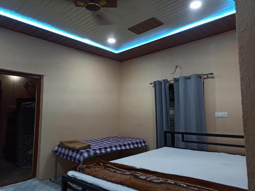 a room with two beds and a shower at Shree krishn yatri nivas in Ellora
