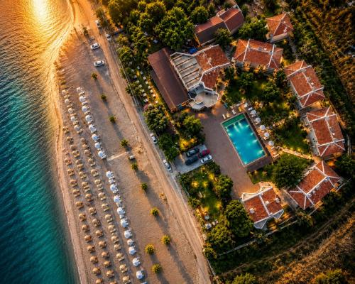 an aerial view of a house next to the water at Blue Park Beach Otel in Ayvacık