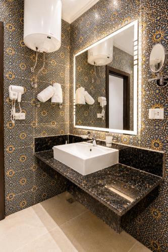 a bathroom with a sink and a mirror at Blue Lotus Nile Suites Hotel Aswan in Aswan