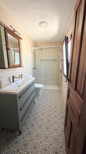 a bathroom with a sink and a toilet and a shower at La Casa del Rey Alhamar in Arjona