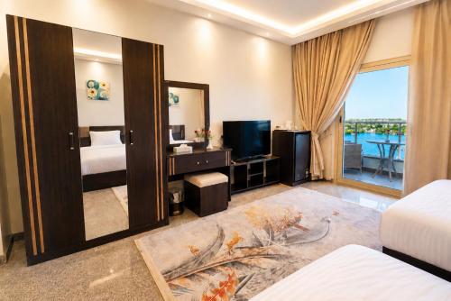 a hotel room with a bed and a mirror at Blue Lotus Nile Suites Hotel Aswan in Aswan
