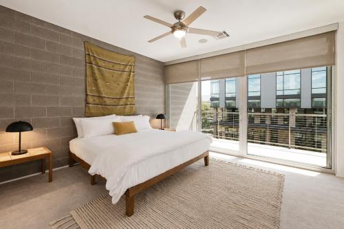 a bedroom with a bed and a large window at Tempe Lofts in Tempe