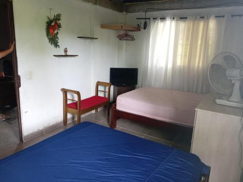 a room with a bed and a table and a chair at Senderos de Ana in San Carlos