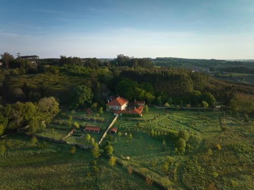 an aerial view of a house in a field at Hotel Pazo de Bieite in Boimorto
