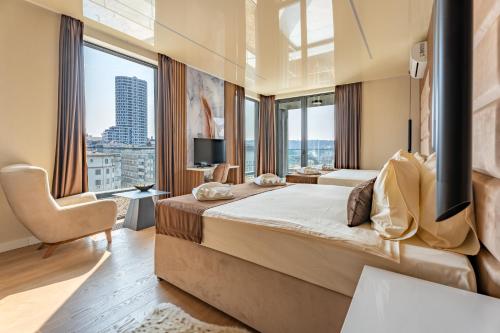 a hotel room with two beds and a large window at Hotel Eterna Hill Rooftop in Sajmište
