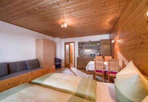 a bedroom with a bed and a dining room at App. Fam. Dr. Goldberger in Söll