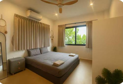 a bedroom with a large bed with a window at V36A Horizon in Haad Yao