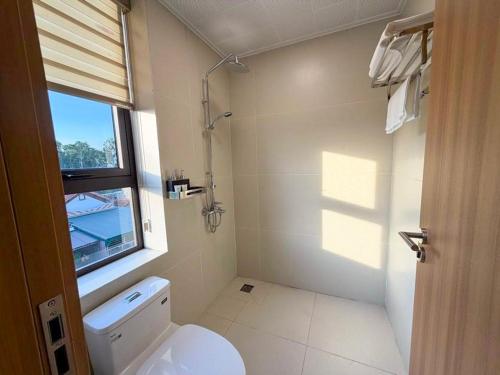 a bathroom with a white toilet and a window at Sơn Trà 668 in Sa Vi Xom