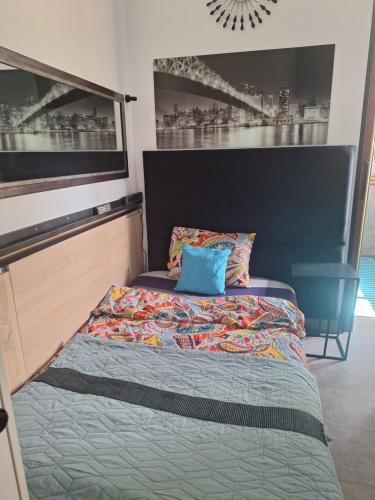 a bed with a blue pillow on top of it at Noclegi 2 pokoje in Szczecinek