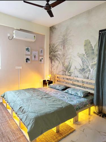 a bedroom with a bed and a painting on the wall at HideAway in Hyderabad