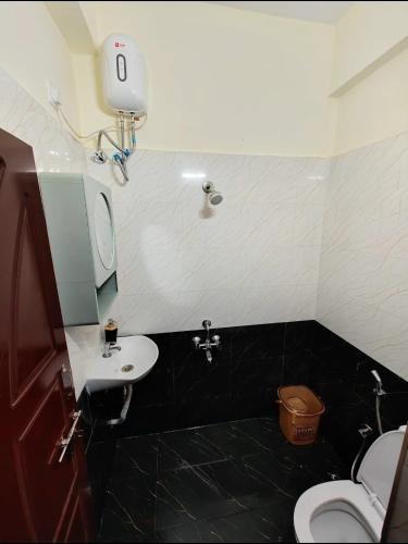 a bathroom with a toilet and a sink at HideAway in Hyderabad