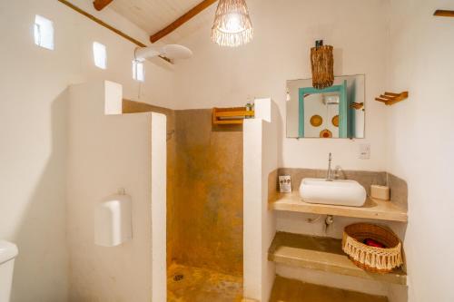 a bathroom with a sink and a mirror at Pousada do Rio Caraíva in Caraíva