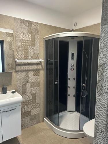 a glass shower in a bathroom with a toilet at Tropical Beach in Eforie Sud