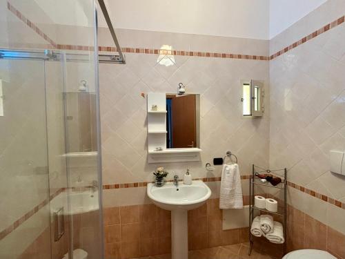 a bathroom with a sink and a shower at La Casa Sulla Scogliera in Cefalù