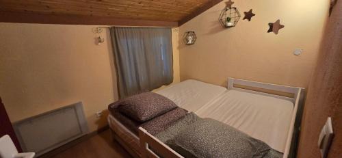 a small bedroom with a bed and a window at Gite chez kinou in Montans