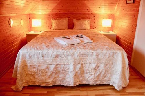 a bedroom with a bed with two towels on it at Guesthouse Árný in Vestmannaeyjar